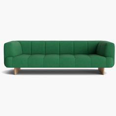 a green couch sitting on top of a white floor