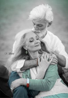 an older couple embracing each other in black and white