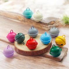 small colorful teapots sitting on top of a wooden tray