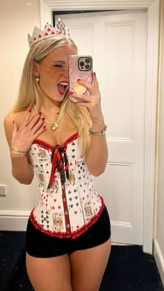 a woman taking a selfie with her cell phone wearing a corset and crown