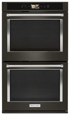 two ovens side by side, one with the door open and one with the light on