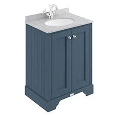 a bathroom vanity with a white sink and blue cabinet