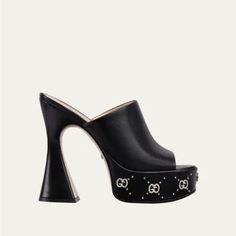 Gucci 115mm Janaya Platform Leather Slide Sandals In Black Size: 36eu Condition: Nwb Gucci "Janaya" 70s Smooth Leather Sandals 4.50 In / 95 Mm Block Heel; 1.50 In / 40 Mm Platform Open Toe Wide Band Vamp Gg Studs Slip-On Style Leather Outsole Made In Italy Gucci Open Toe Heels With 4-inch Heel, Luxury Gucci Evening Sandals, Gucci Calf Leather Sandals For Evening Wear, Luxury Closed Toe Platform Heels, Gucci Formal Platform Heels, Gucci Calf Leather Sandals With Heel Strap, Luxury Platform Heels With Closed Toe, Gucci High Heel Sandals For Evening, Gucci Leather Heels With 4-inch Heel