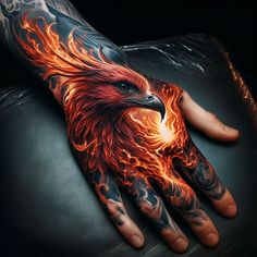 a hand with an eagle on it and flames coming out of the middle of it