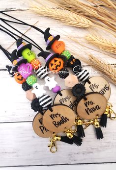 halloween themed wooden keychains with black tassels and jack - o'- lanterns