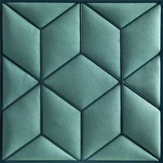 a close up view of a green tile wall