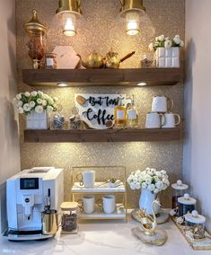 a kitchen counter with coffee cups and mugs on it