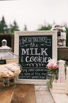 there is a sign that says we go together like milk and cookies on the table