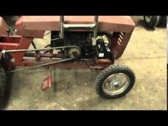 a red lawn mower sitting on top of a cement floor