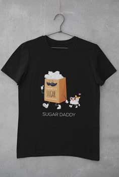 Welcome to the Sugar Bowl! Or shall we say packet? Whether if you are a Sugar Daddy, Sugar Mama or Sugar Baby, this is the tshirt that spills sweetness into your life. This fun tshirt is the perfect present for all those lovely sugary people that are important to you. It is your turn to spoil them and have a laugh at once. No Sugar Daddy? No problem. You can be your own Sugar Mama or your own Sugar Daddy. DISCLAIMER: Staring at this tshirt for more than 5 minutes might cause cavities * 100% ring Cotton Slogan T-shirt As Gift, Family Matching Cotton T-shirt Gift, Family Matching Graphic Print T-shirt As Gift, Cute Black T-shirt For Father's Day, Cute Text Print T-shirt As Gift, Novelty Letter Print T-shirt As Gift, Cute Slogan T-shirt For Gifts, Cute Slogan T-shirt For Gift, Funny Print Cotton Shirt As A Gift