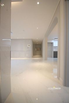 an empty room with white walls and floors