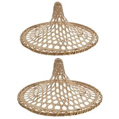 two round wicker trays with handles on each side, one holding an object