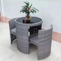 a table and chairs with a potted plant on top