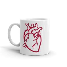 a white coffee mug with a red heart on it