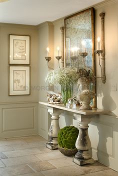 a room with two tables and vases filled with flowers