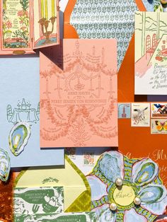 an assortment of different colored cards and envelopes with designs on them, all in various shapes and sizes