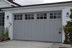 a white house with a gray garage door