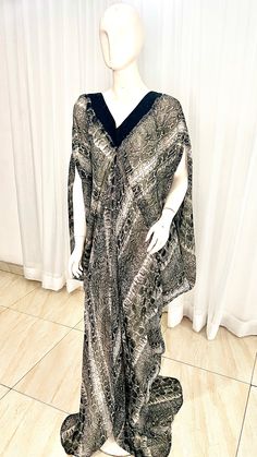 This Silk Kaftan maxi dress is made with Polysilk and Lace Front. It can be styled in different ways, you can dress it up with high heels or dress down with flats/sneakers. The Hand can be worn in 2 ways. one way shows off the arm, the 2nd way has the arm covered for modesty. Notice the slits.Other prints are also available, kindly start a conversation to ask for more information and pics.Contact us for custom looks and more style options. Sizing 🌺 Your height or desired kaftan length is needed Elegant Flowy Full-length Maxi Dress, Flowy Full-length Maxi Dress For Party, Elegant Backless Maxi Dress For Vacation, Chic Full Length Silk Maxi Dress, Flowy Long Kaftan For Spring, Flowy Long Dress Kaftan For Spring, Black Silk V-neck Maxi Dress, Black Bohemian Maxi Dress For Night Out, Elegant Spring Maxi Dress For Beach Cover-up