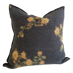 a black pillow with yellow flowers on it