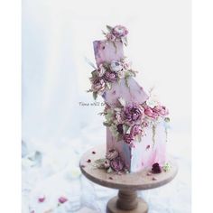 a cake decorated with flowers on top of a table