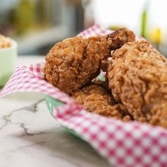 some fried food is in a basket on the table