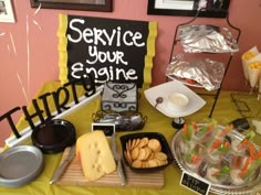 there is a table with food on it that includes cheese, crackers and other items