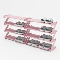 three pink shelves with shoes on them