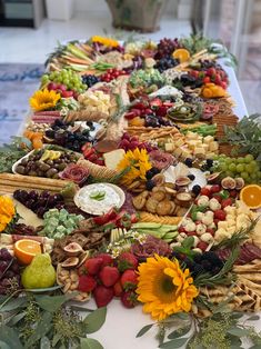 a table topped with lots of different types of food and fruit on top of it