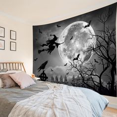 a black and white photo of a halloween scene with witch flying over the full moon