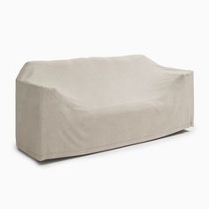 a white couch sitting on top of a white floor