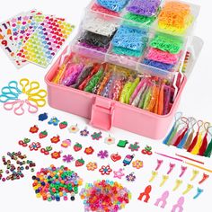 a pink box filled with lots of different types of beads and hair accessories on top of a white surface