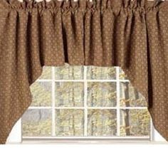 a window with a curtain in front of it and trees outside the window sill