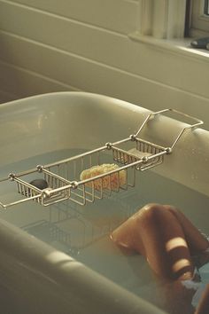 a bathtub filled with water next to a window