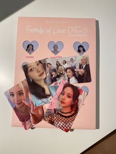 a pink book with pictures of women on the front and back cover, sitting on top of a white table