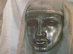 a close up of a statue with a veil on it's head and eyes