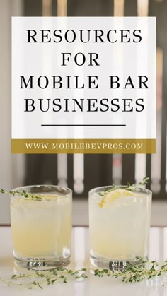 two glasses filled with lemonade sitting on top of a table next to each other