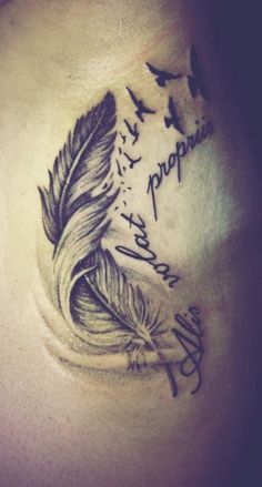 a woman's chest with a feather and writing on it