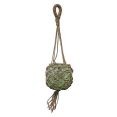 a green purse hanging from a rope