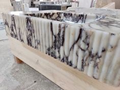 a marble counter top sitting on top of a wooden table