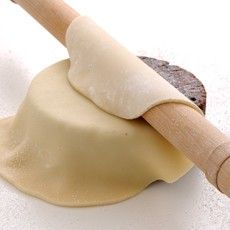 a rolling pin with dough on top of it