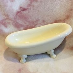 a white bath tub sitting on top of a table