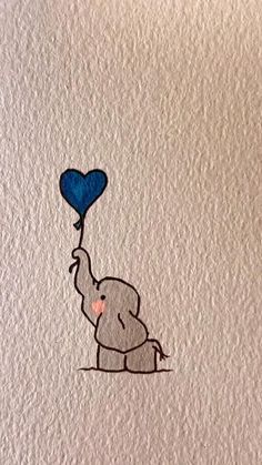 an elephant holding a blue heart shaped balloon