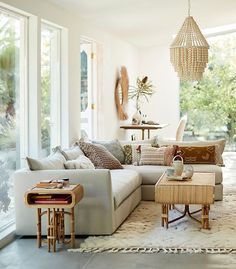 a living room filled with lots of furniture and decor on top of a white rug