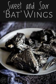 sweet and sour bat wings on a plate with text overlay that reads, sweet and sour bats