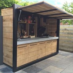 an outdoor kitchen made out of wood and metal