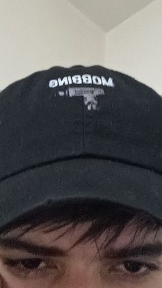 a close up of a person wearing a hat with the word mobbing on it