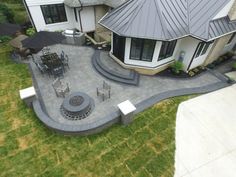 an aerial view of a house with patio and seating area