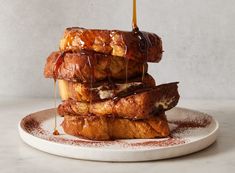 a stack of french toast on a plate drizzled with caramel syrup