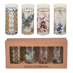 four glass tumblers in a cardboard box with floral designs on the front and sides