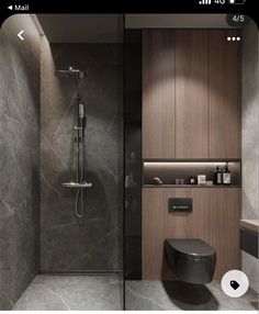 a bathroom with a toilet, sink and shower stall in grey marbled stone walls